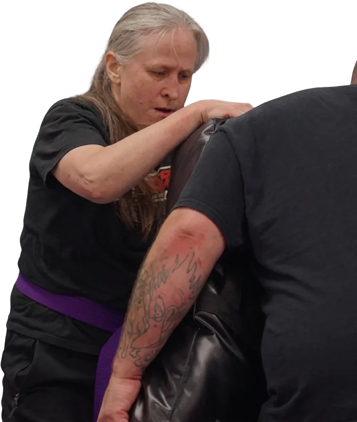 Two adults training a clinch on a pad during Krav Maga class at K3 Martial Arts
